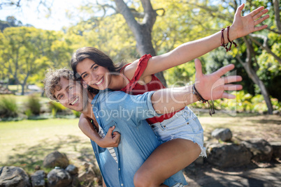 Man giving a piggyback ride to woman