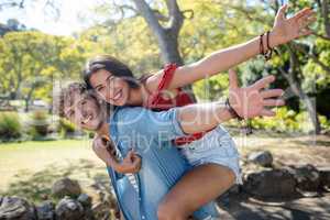 Man giving a piggyback ride to woman