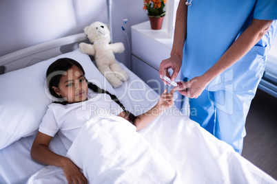 Female doctor checking a sugar level of patient