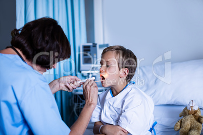Female doctor examining patient mouth
