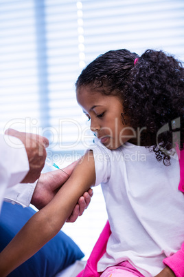 Doctor giving an injection to the patient