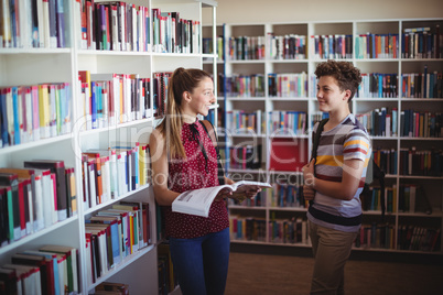 Classmates interacting with each other in library