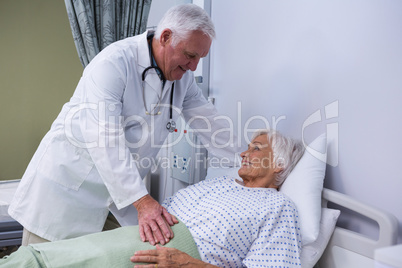 Doctor consoling senior patient