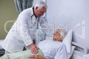 Doctor consoling senior patient