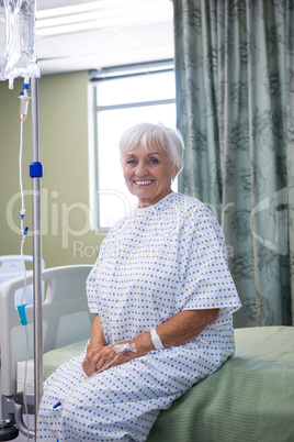 Portrait of smiling senior patient on bed