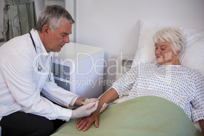 Doctor giving injection to senior patient
