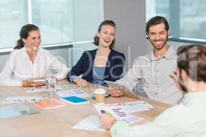 Business executives discussing with each other in conference room