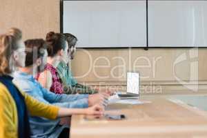 Business executives listening to a presentation in conference room
