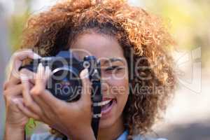 Woman taking picture with digital camera