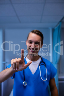 Portrait of doctor gesturing in ward