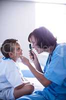 Female doctor examining patient with ophthalmic device