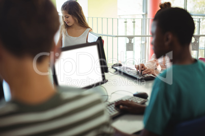 Students using computer in classroom