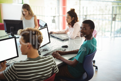 Students using computer in classroom