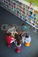 Students interacting with each other in library