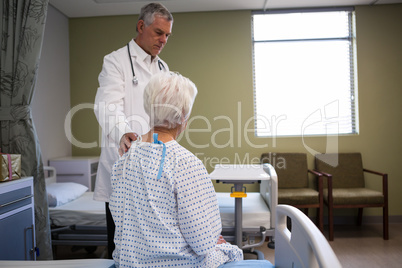 Doctor consoling senior patient