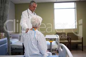 Doctor consoling senior patient