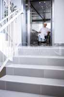 Disabled senior patient on wheelchair in lift