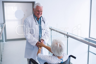 Doctor holding hands of senior patient