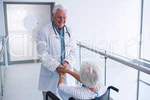 Doctor holding hands of senior patient