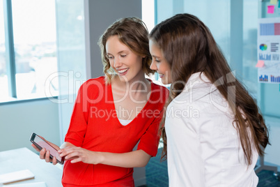 Business executives discussing over mobile phone