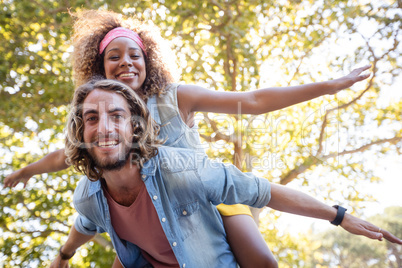 Man giving a piggyback ride to woman