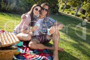Happy couple having picnic in the park