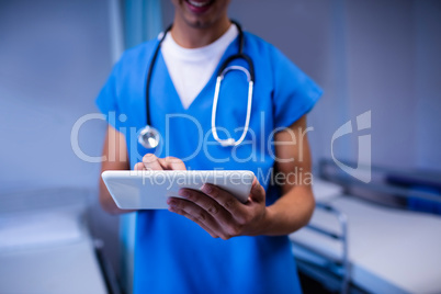 Doctor using digital tablet in ward at hospital