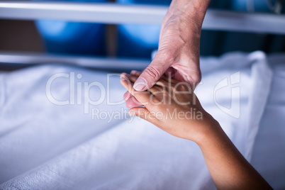 Doctor checking girls hand in the hospital