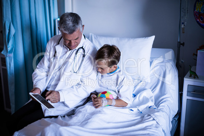 Doctor showing medical report in digital tablet to patient