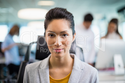 Portrait of beautiful business executive sitting on chair