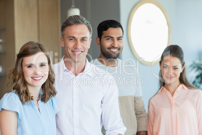 Smiling business executives standing together in office