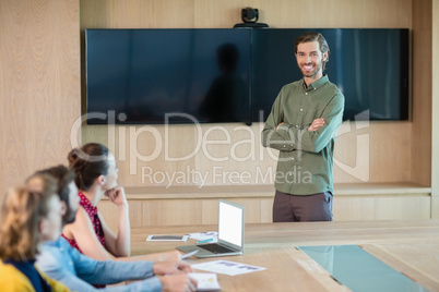 Business executive giving presentation to colleagues