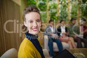 Business executive smiling while sitting in office lobby