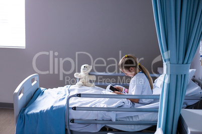 Patient using digital tablet in ward