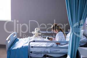 Patient using digital tablet in ward