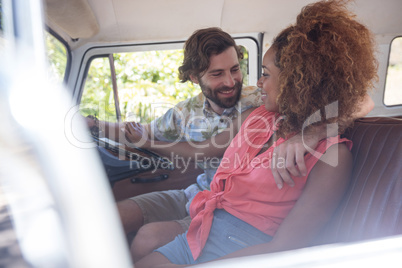 Couple interacting with each other in campervan