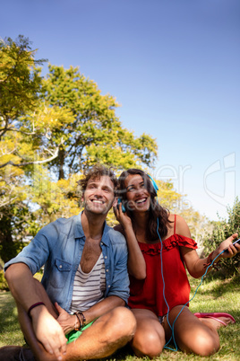 Couple listening to music in park