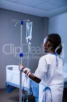 Patient holding IV stand