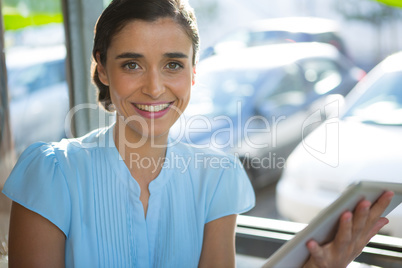 Female executive using digital tablet at cafÃ?Â©