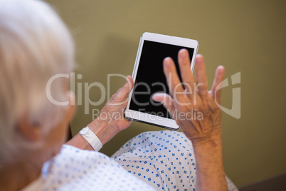 Senior patient using digital tablet to video chat