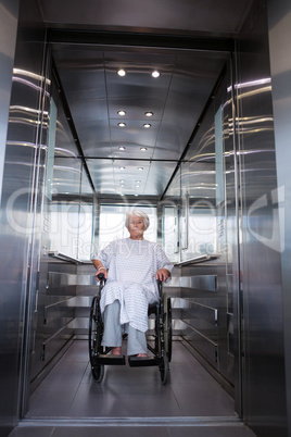 Disabled senior patient on wheelchair in lift