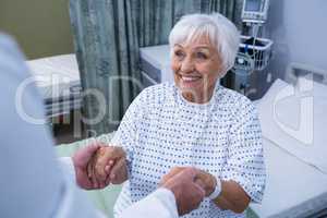 Senior patient taking assistance from the doctor