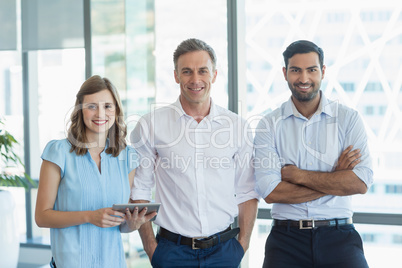 Business executives smiling while standing in office