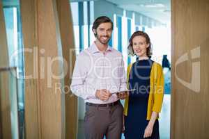 Business executives smiling while standing in office