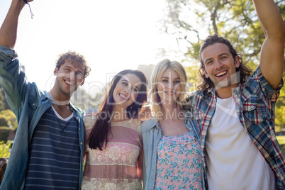 Friends standing together in park