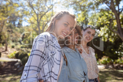 Female friends standing together with arm around