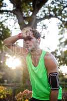 Tired man taking a break while jogging