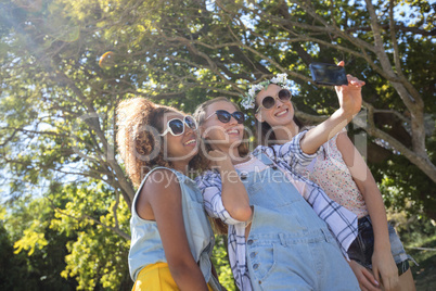 Female friends taking selfie with mobile phone