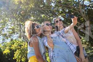 Female friends taking selfie with mobile phone