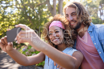 Happy couple taking selfie on mobile phone